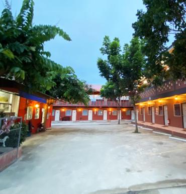 an empty parking lot in front of a building at Panngernpanthong inn resort in Ban Nong Chaeng