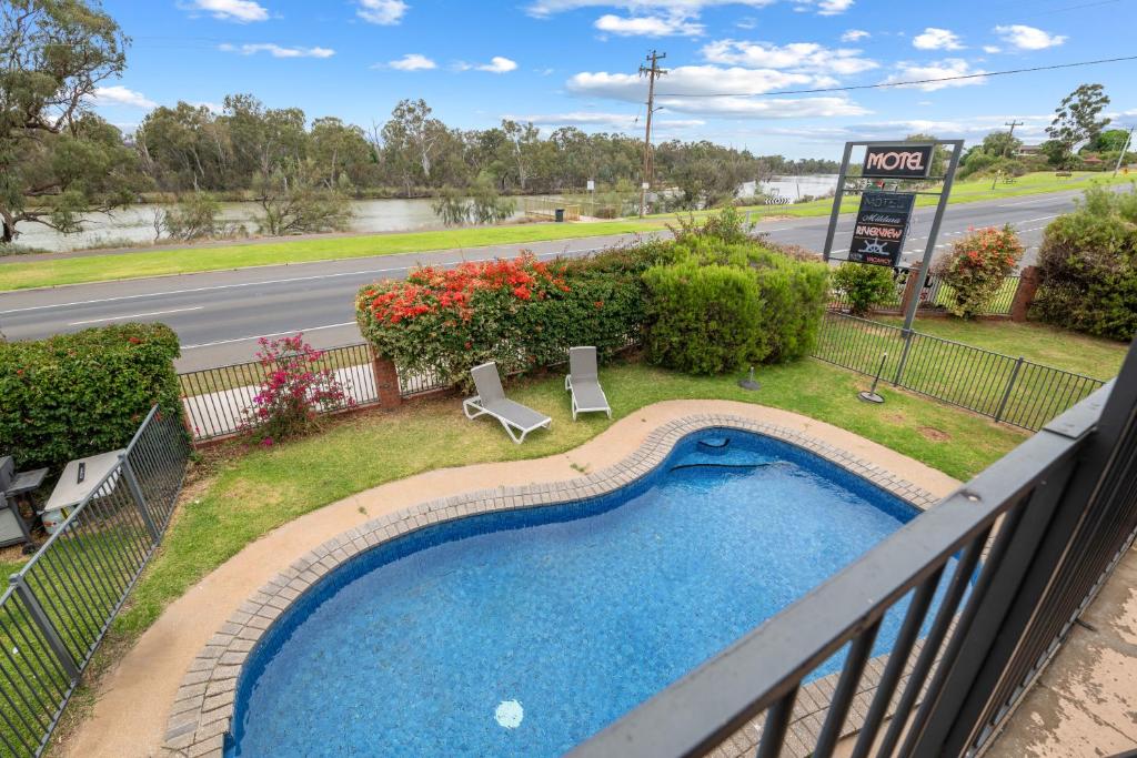 a balcony with a swimming pool and a road at Mildura Riverview Motel in Gol Gol