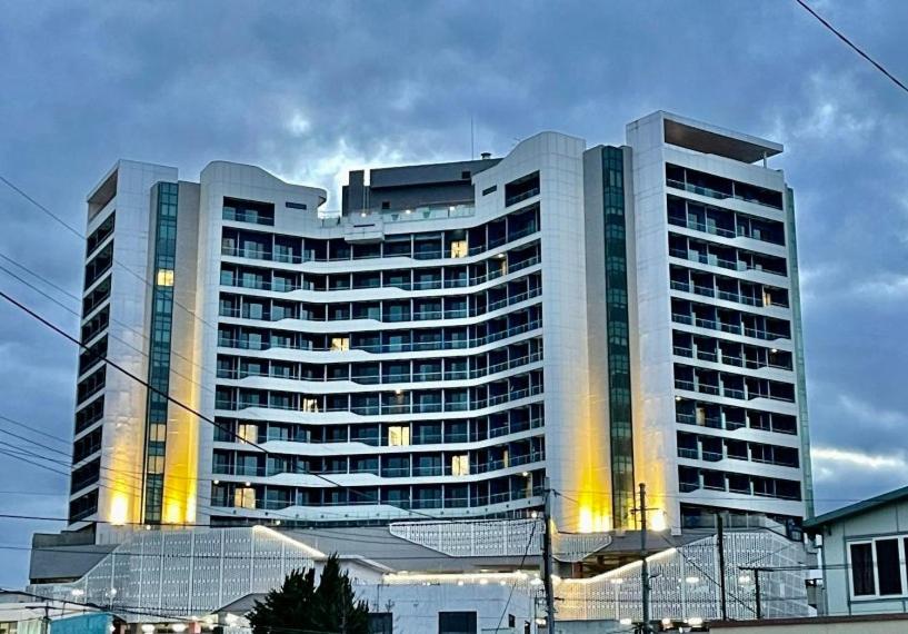 a large building with yellow lights in front of it at Nova Stay Gangneung in Chumunjin