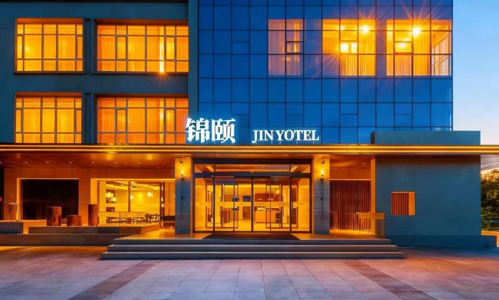 a building with a sign on the front of it at Jin Yi Hotel Chifeng Victoria Mall Hongshan Government Branch in Liu-tao-fen
