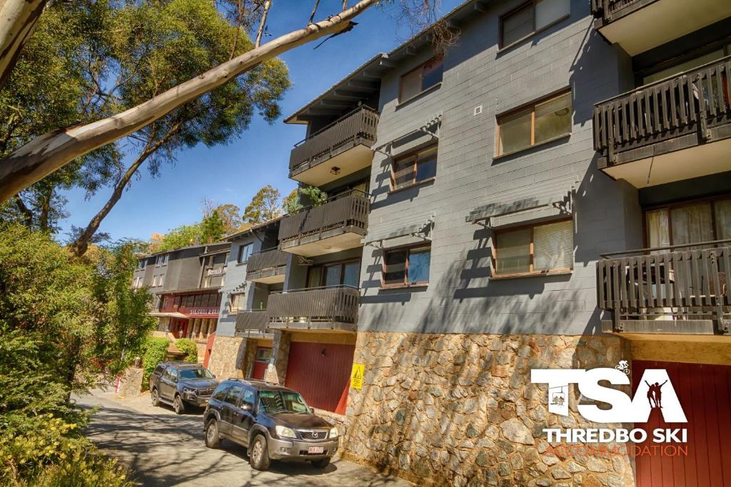 a building with cars parked in front of it at Mowamba E6 in Thredbo