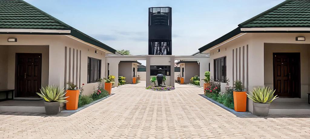a courtyard of a house with plants in front of it at Better value stay in Lusaka