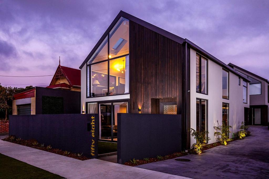 a house with large glass windows on the side of it at Modern Luxury In New Plymouth - relax and explore in New Plymouth