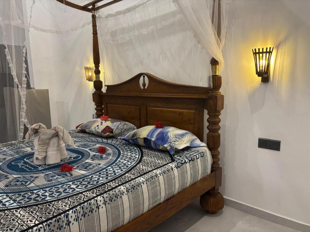 a bedroom with a wooden bed with a canopy at Cinnamon Luxury Villa,Beruwala,Bentota in Beruwala