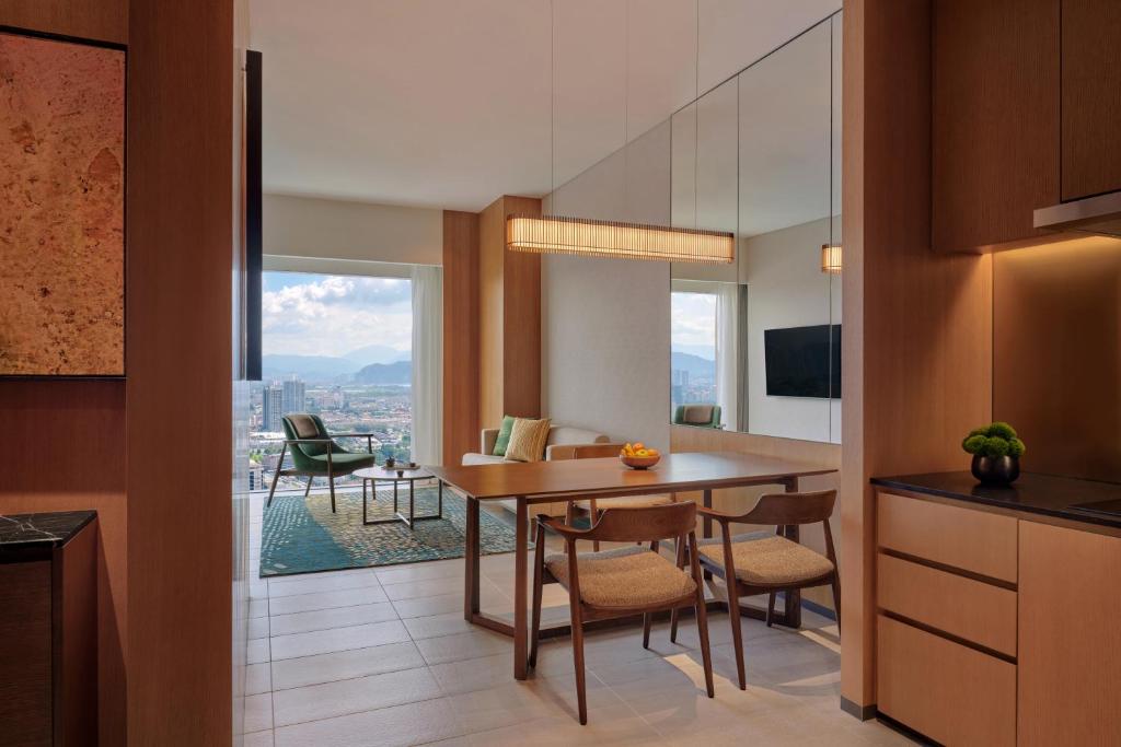 A compact kitchen and dining area opens into a bright sitting space with a city view.