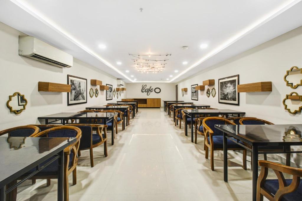 a row of tables and chairs in a restaurant at Super Hotel O D Suites in Hyderabad
