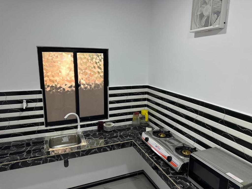a kitchen counter with a sink and a window at Trikon Villaa in Trincomalee