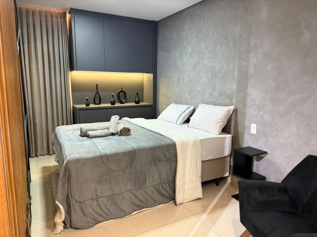 a bedroom with a large bed in a room at DNA Flat Experiência, novo e lindo, com piscina incrível in Goiânia