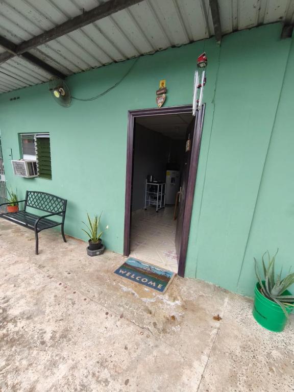 a house with a blue wall and a door at Yayunaturals 1 in Panama City