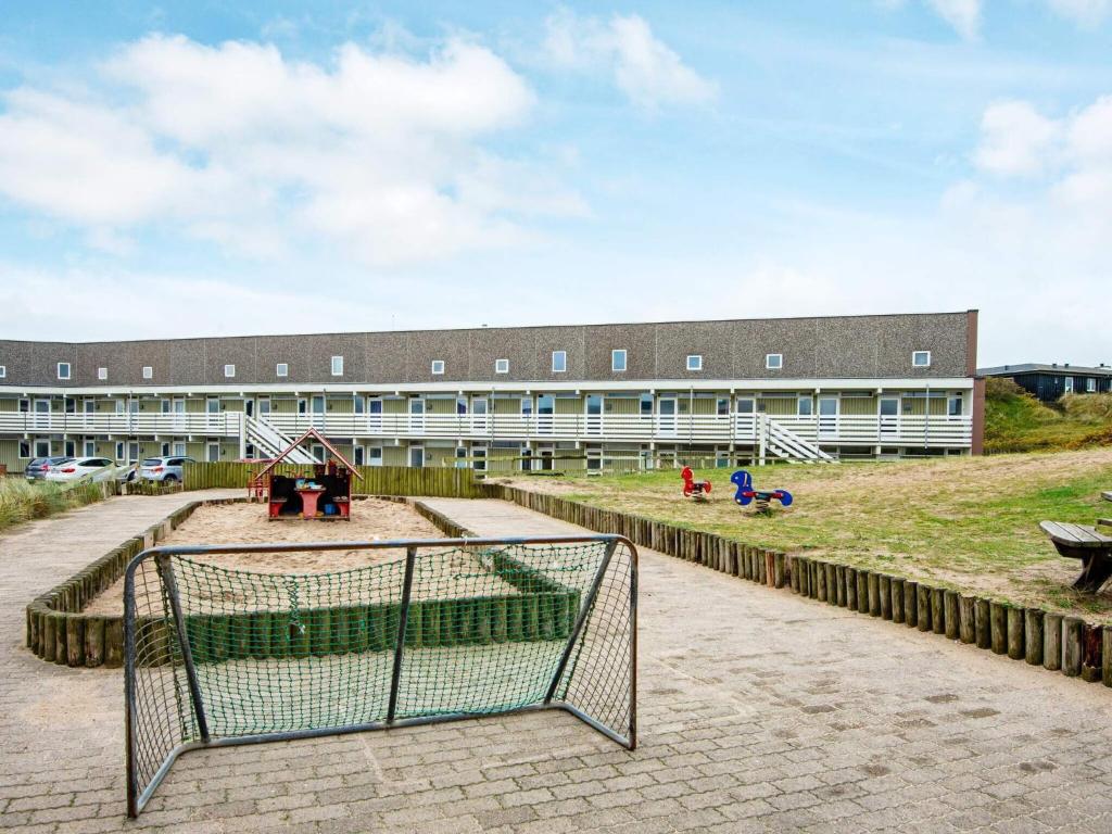 a school building with a playground in front of it at 4 person holiday home in Ringkøbing in Ringkøbing
