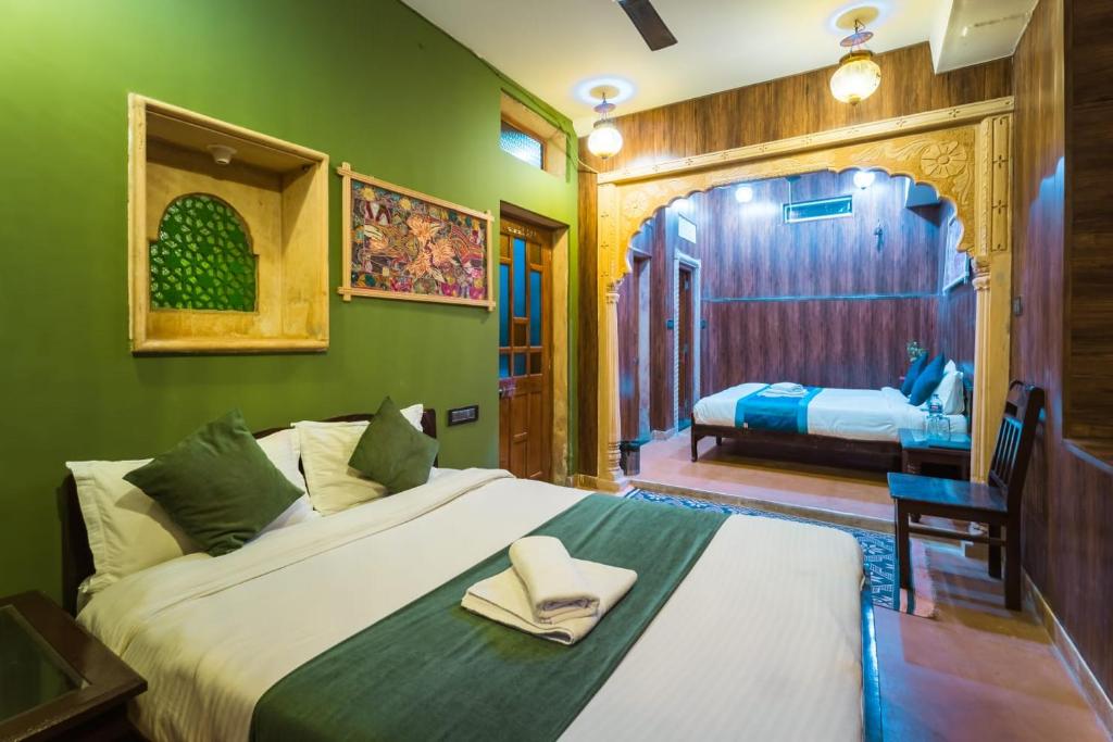 - une chambre avec un grand lit et une chambre d'une superficie de 2 m2 dans l'établissement Hotel The Vintage villa Jaisalmer, à Jaisalmer
