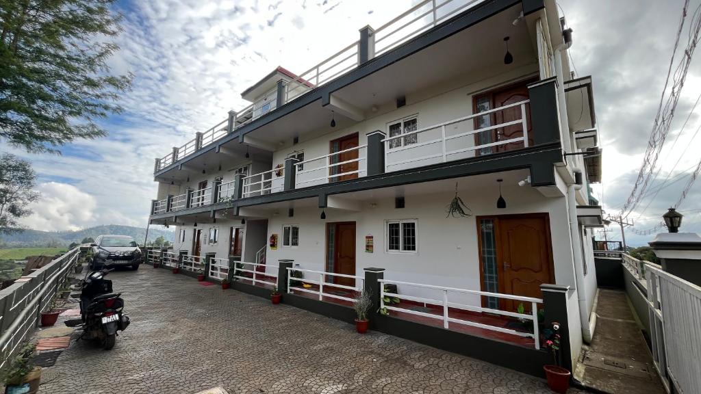 a building with a motorcycle parked in front of it at Vivens Villas in Ooty