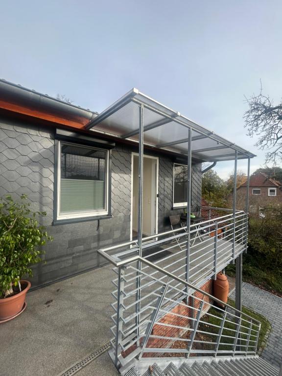 a house with a metal staircase in front of it at Ferienwohnung Weber in Bergen