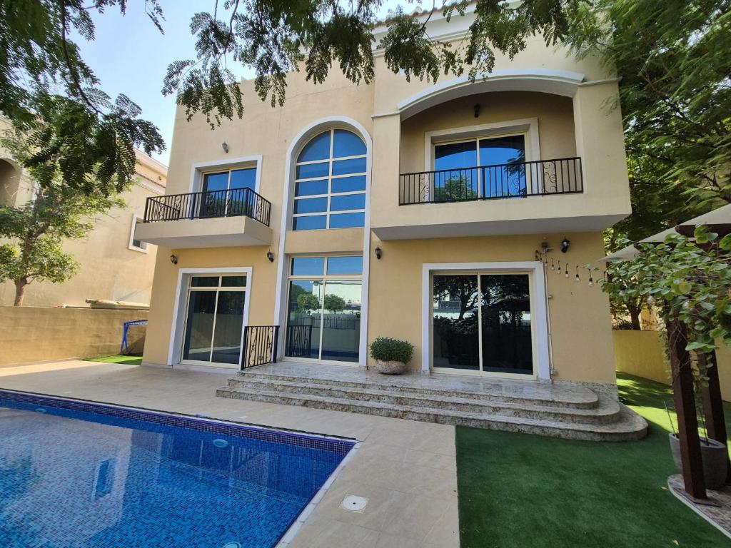 a house with a swimming pool in front of it at Élégante Villa de Luxe 5 Chambres avec Piscine Privée in Dubai
