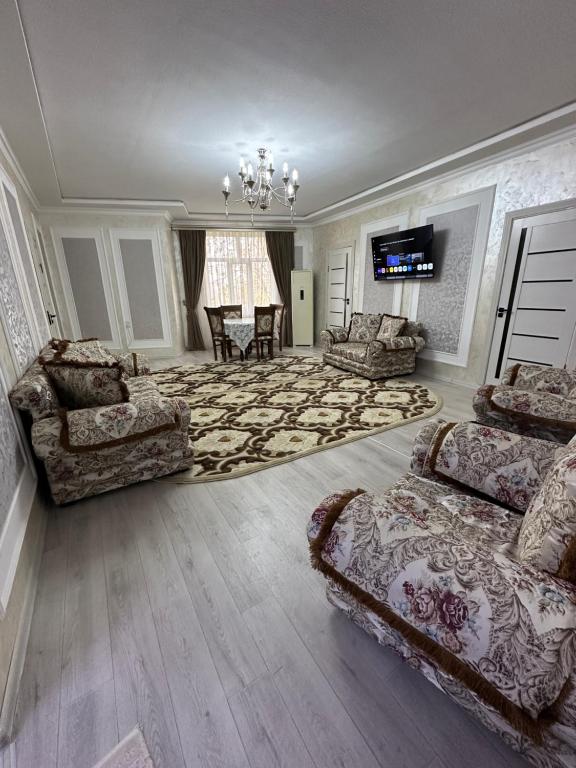 a large living room with two couches and a television at Apartment Nabi Bobo in Samarkand