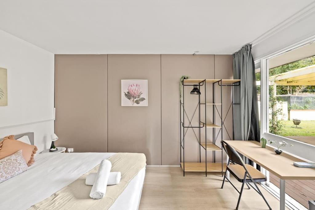 sypialnia z łóżkiem, biurkiem i umywalką w obiekcie Bright and Cozy Queen Room - Serene Spot at Pymble - Shared Bathroom w mieście Turramurra