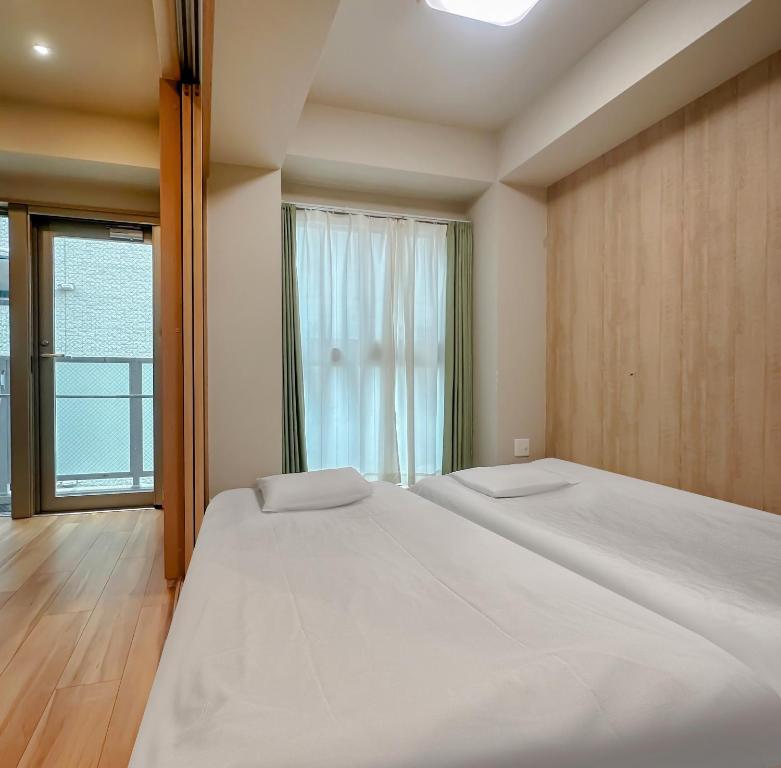 Ένα ή περισσότερα κρεβάτια σε δωμάτιο στο Dc桜の苑-花園町店