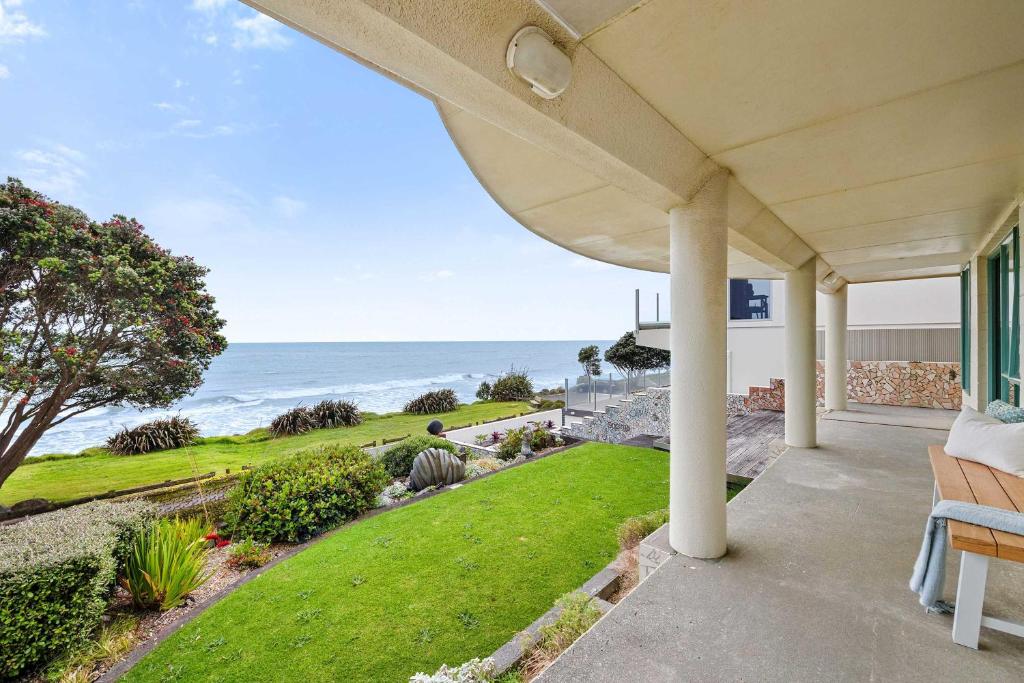 a view of the ocean from the porch of a house at Wanaka Studio - sea views from your private patio in New Plymouth