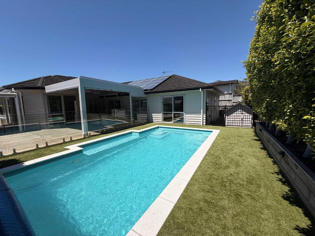a swimming pool in front of a house at Millwater Retreat in Silverdale