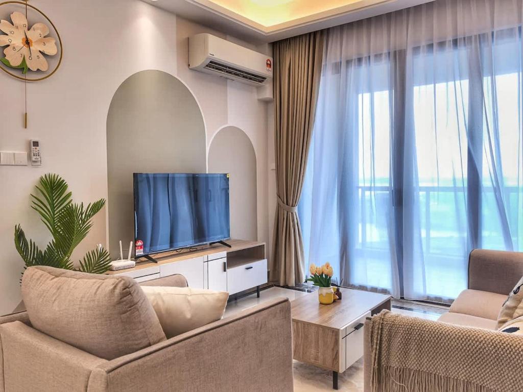 a living room with a large window and a television at R&F Princess Cove 2BR Sea View JB CIQ Spacious in Johor Bahru