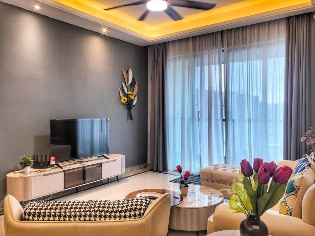 a living room with a couch and a tv at R&F Princess Cove 3BR CozyDesign JB Central CIQ in Johor Bahru