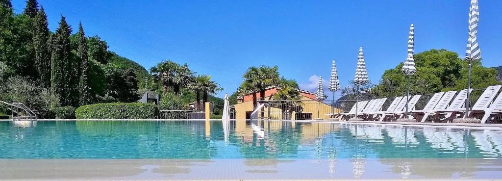 a large pool of water in front of a building at Residence Corte Camaldoli in Garda
