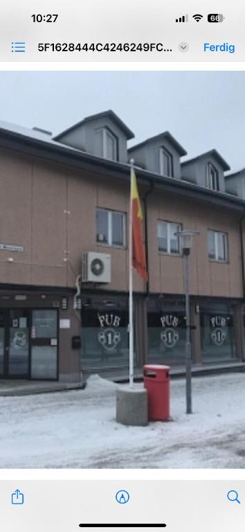 a picture of a building with a flag in front of it at Kirkenes town apartments in Kirkenes
