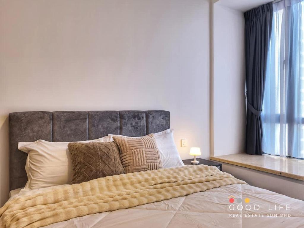 a bedroom with a large bed with a large headboard at Queen Room R&F Princess Cove Shared Common Space in Johor Bahru