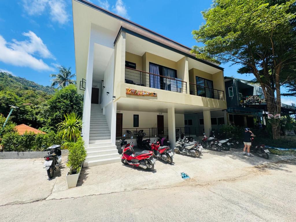 a group of motorcycles parked in front of a building at Cozy Apartment at Chaweng Hill in Amphoe Koh Samui