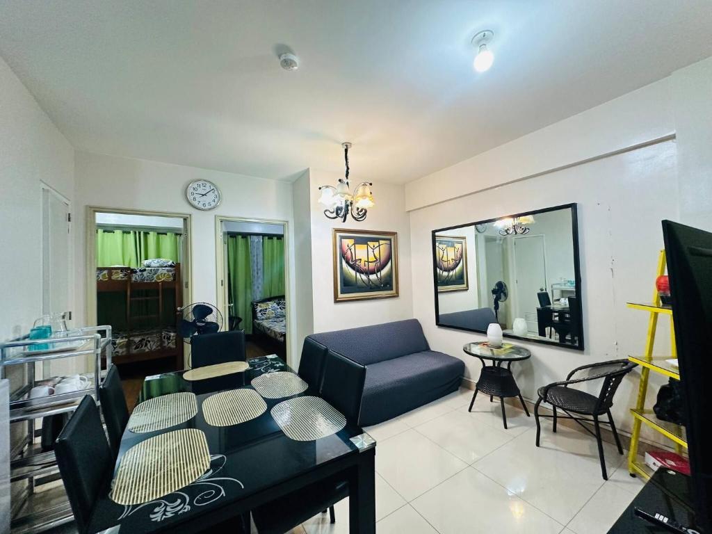 ein Wohnzimmer mit Sofa und Tisch in der Unterkunft Optomum Davao City Apartment for Rent - Peaceful Living near Abreeza Mall in Cabaguio