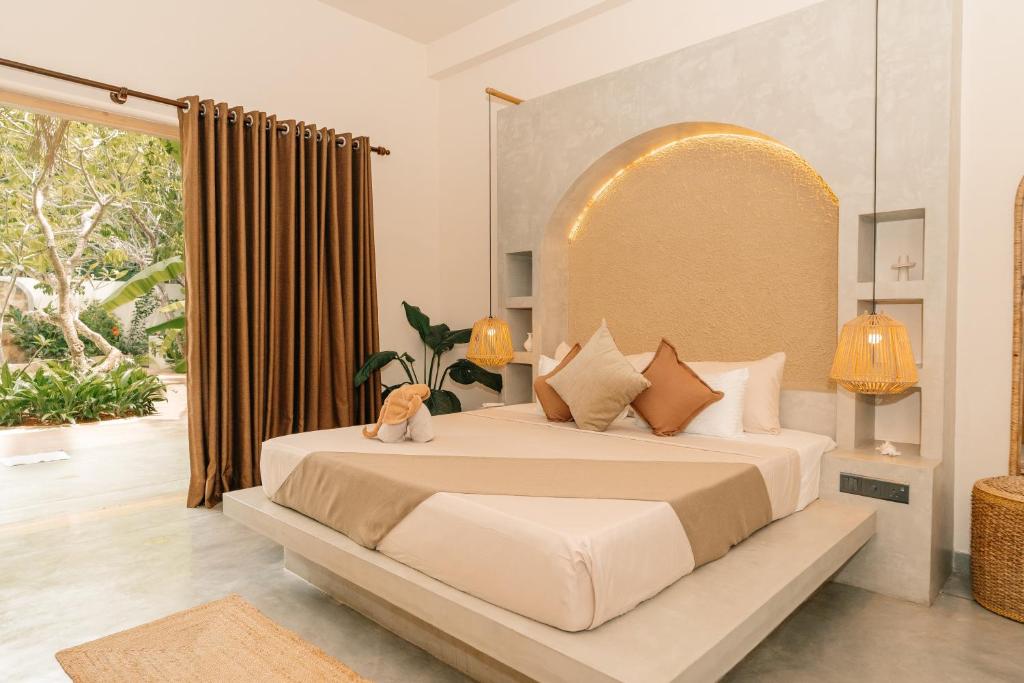 a bedroom with a large bed with a large window at Oura Spirit in Unawatuna