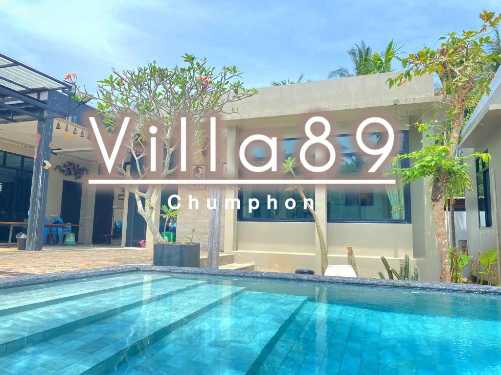 a hotel with a swimming pool in front of a building at Villa89 Chumphon 