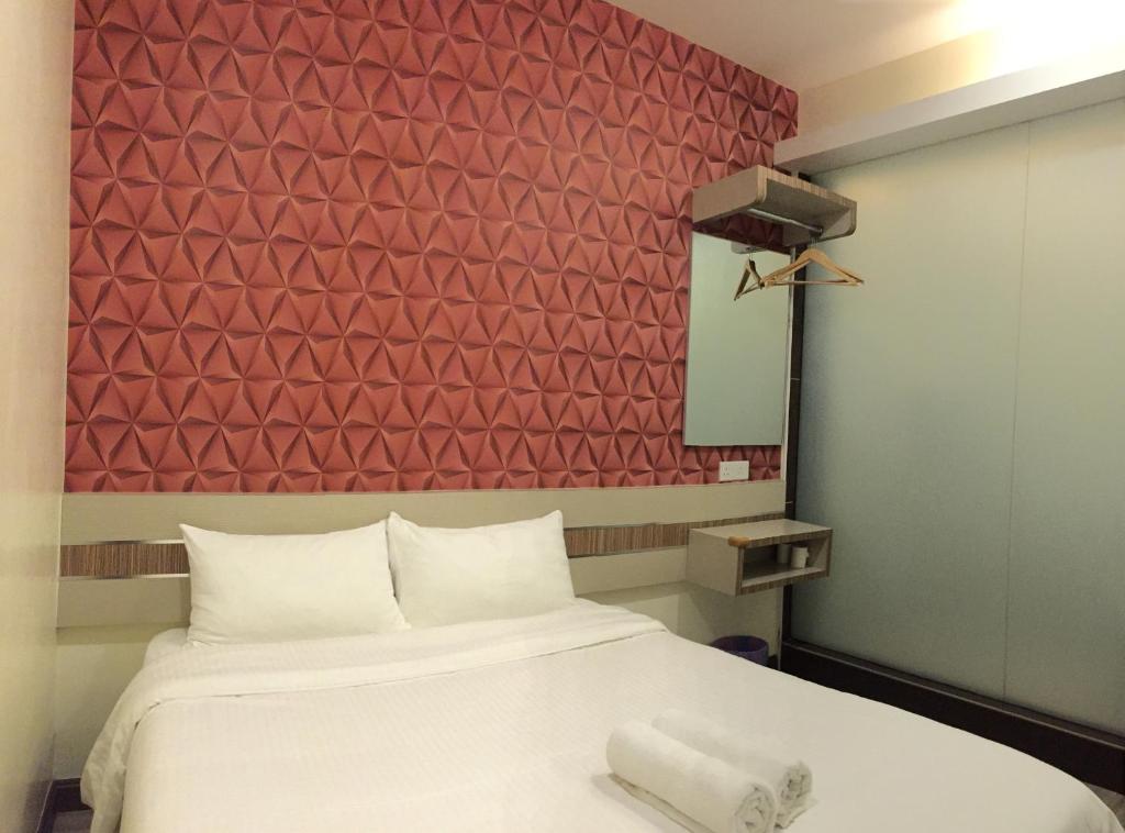 Postel nebo postele na pokoji v ubytování Hotel Alor Gajah