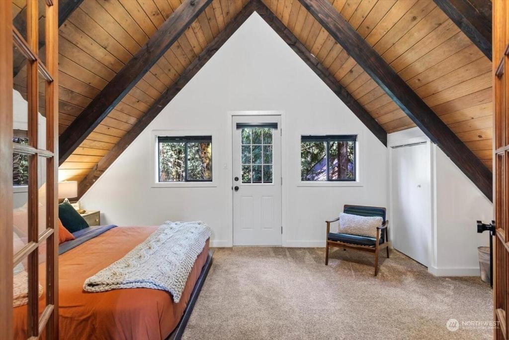 a bedroom with a bed and a wooden ceiling at Luxury A-Frame with Hot Tub, Fireplace & Firepit in Skykomish