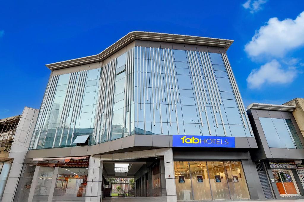 a tall building with a sign on it at FabHotel The Royal Kishan Complex in Noida