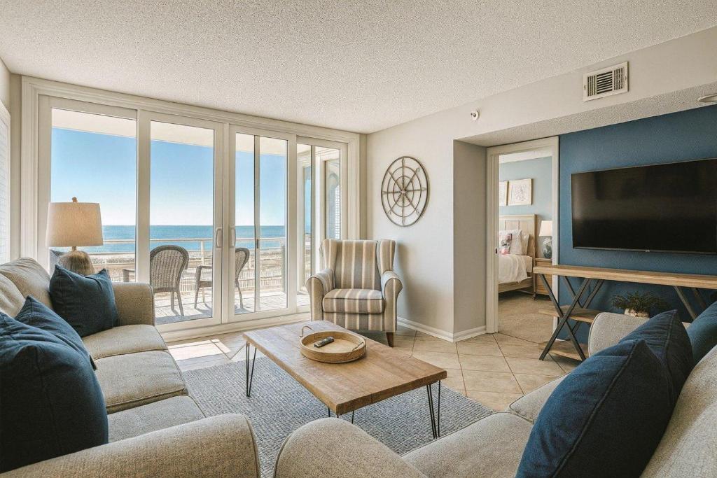 a living room with a couch and a tv at Atlantic Dunes - 101 in Myrtle Beach