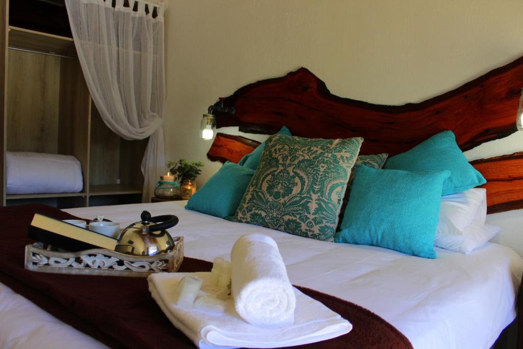 a hotel room with a bed with towels on it at Waterfall Guesthouse in Rustenburg