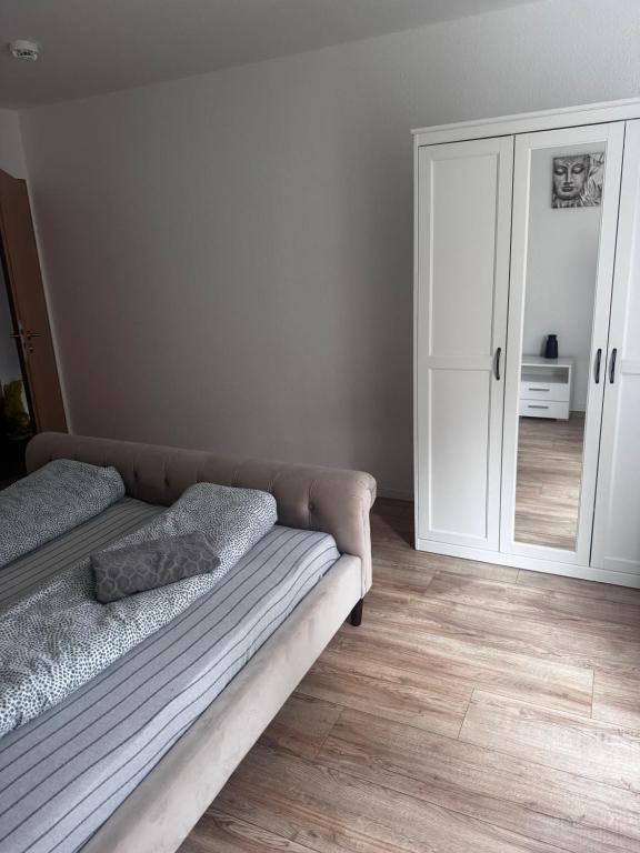 a living room with a couch and a cabinet at Stadtwohnung im Luisenviertel in Wuppertal