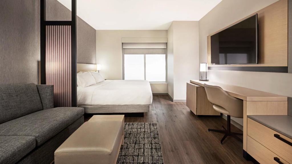 a hotel room with a bed and a desk at Hyatt Place Cariari/Convention Center in Heredia