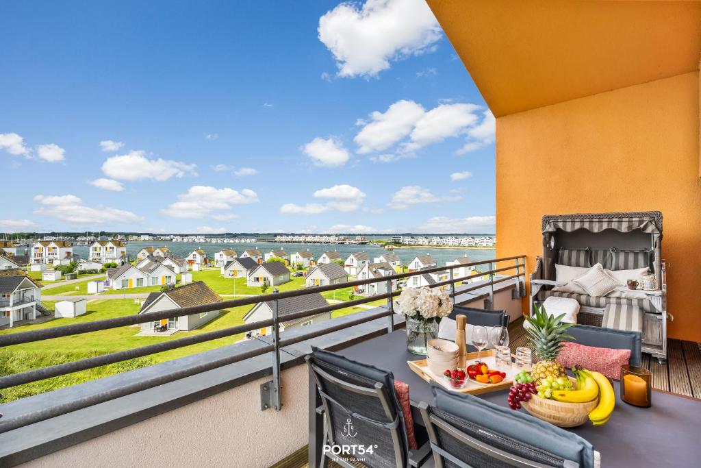 a balcony with a table and chairs and a view of the water at Penthouse Kapitänskajüte, App 25 Olpenitz in Olpenitz