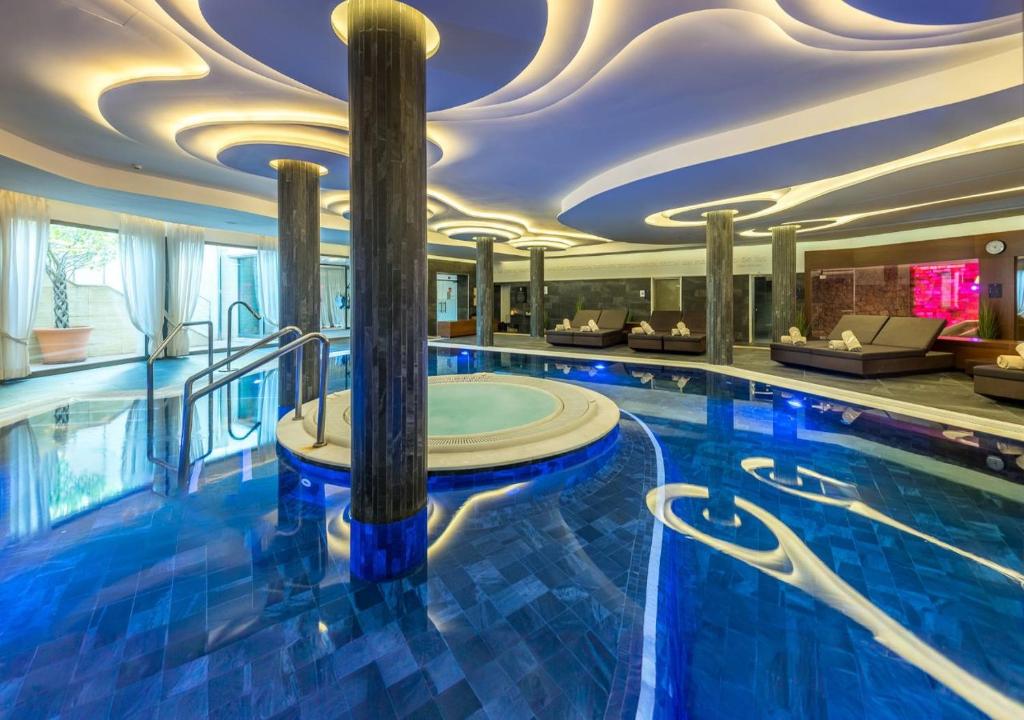 a swimming pool in a hotel with a ceiling at Pure Salt Port Adriano - Adults Only in Santa Ponsa