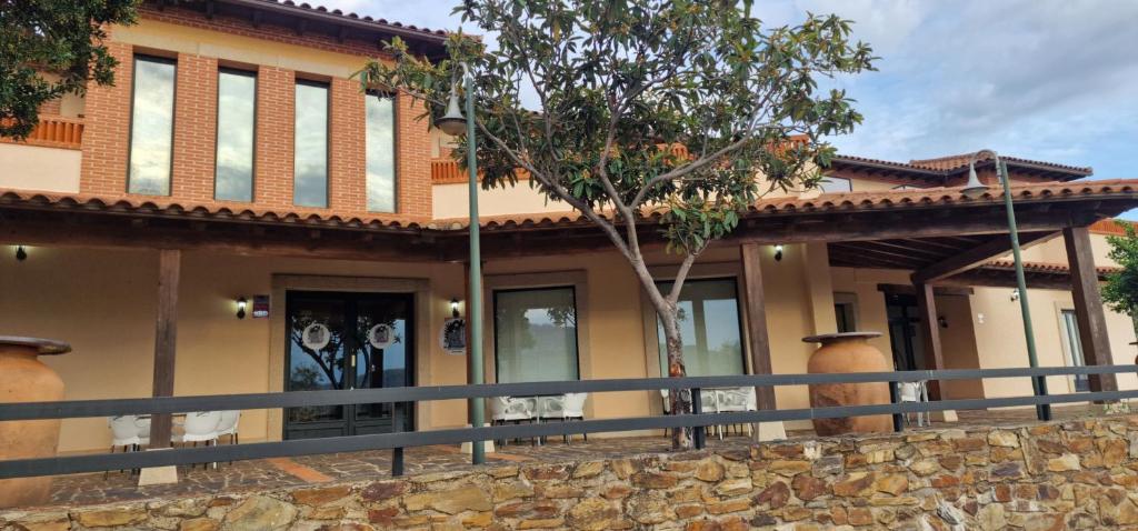 a house with a fence in front of it at Hotel Rural Atalaya in Guadalupe