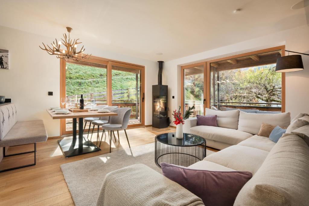 a living room with a couch and a table at Chalet Florian in Kirchberg in Tirol