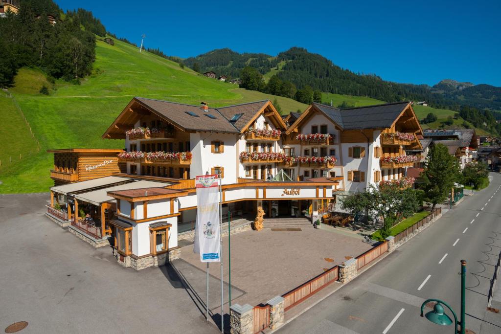 an aerial view of a hotel with a mountain at Hotel Auhof in Grossarl