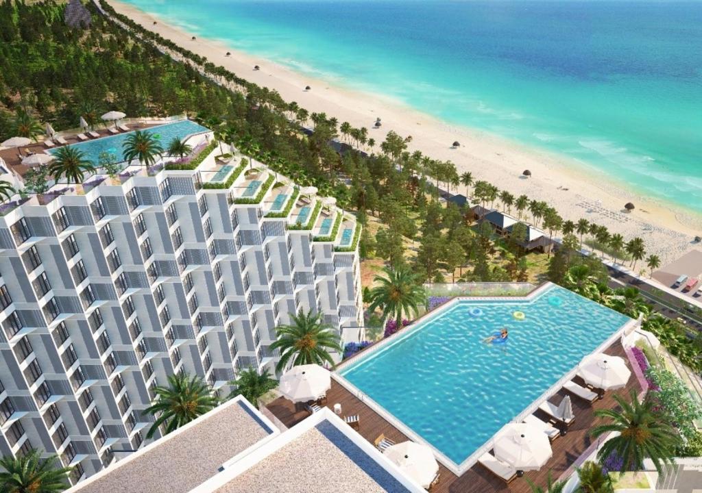 an aerial view of a hotel and the beach at Beachfront Condotel - Free Pool Access - Apec Mandala Mui Ne in Ấp Thiẹn Ái