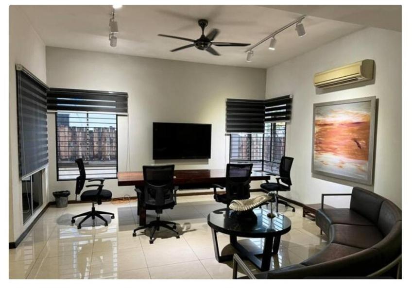 a living room with a couch and a table and chairs at JM House Kuala Lumpur in Puchong