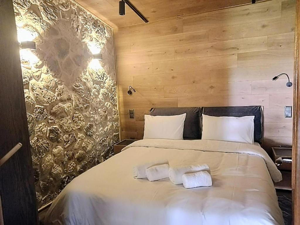 a bedroom with a bed with two towels on it at G&J Traditional House in Elati Trikalon