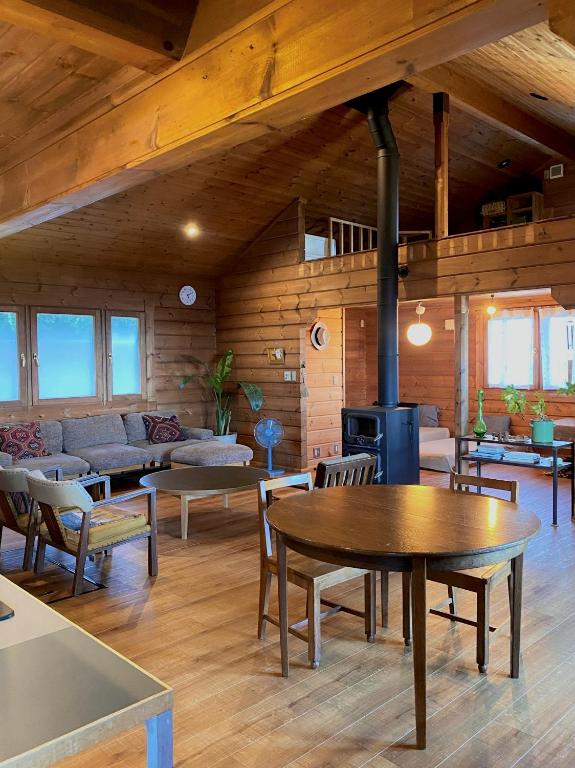 a living room with a couch and a table at 海を眺めるログハウス カマカーマAwaji in Awaji