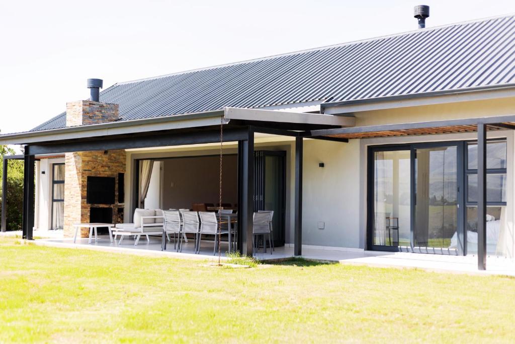 an extension to a house with glass doors at 3BR Drakensberg Retreat, Mountain Views and Braai in Ardmore