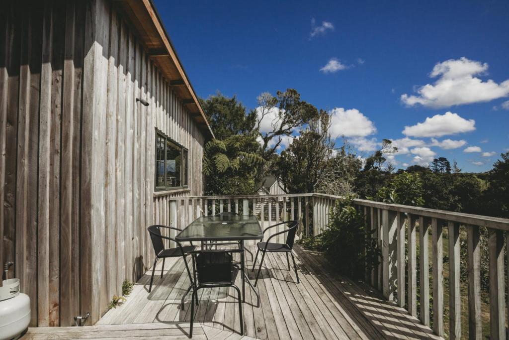 a patio with a table and chairs on a deck at The River Retreat - off the grid escape in Inglewood